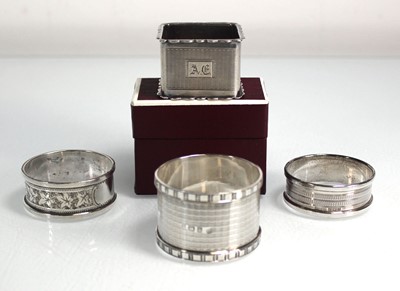 Lot 404 - A group of four silver napkin rings including...