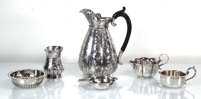 Lot 437 - A metalware water jug of naturalistic form, h....