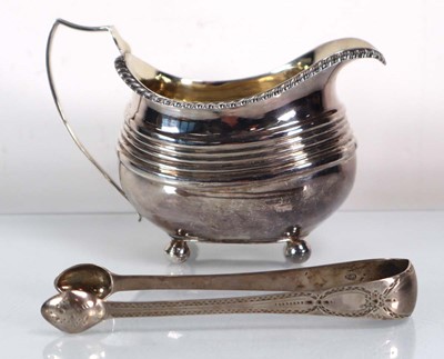 Lot 448 - A Georgian silver milk jug of typical form on...