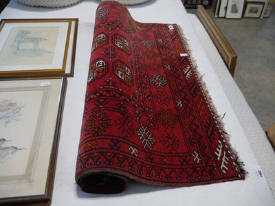Lot 1144 - Woolen red figured and bordered small rug