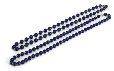 Lot 671 - Two single strand lapis lazuli bead necklaces,...