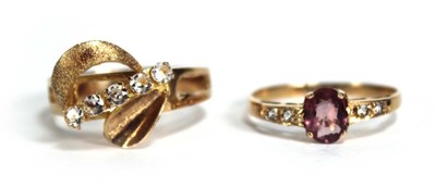 Lot 688 - A yellow metal ring set oval pink stone and...