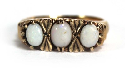 Lot 690 - A 9ct yellow gold ring set three graduated...