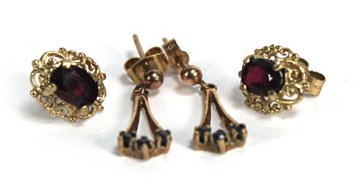 Lot 691 - A pair of 9ct yellow gold ear studs, each set...