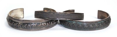 Lot 692 - Three silver cuff type bracelets, two with...