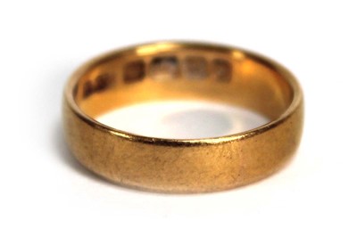 Lot 693 - A 22ct yellow gold wedding band, Birmingham...