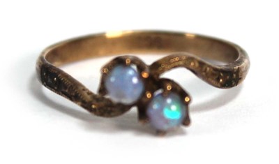 Lot 697 - A 9ct yellow gold crossover ring set two small...