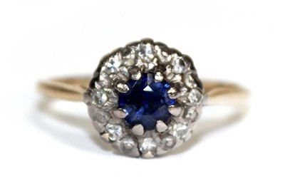 Lot 704 - An 18ct yellow gold cluster ring set sapphire...