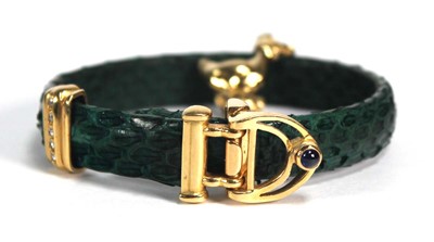 Lot 709 - A faux green snakeskin bracelet with yellow...