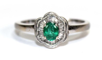 Lot 712 - A 14ct white gold cluster ring set oval...