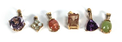 Lot 718 - Six 9ct yellow gold and yellow metal pendants,...