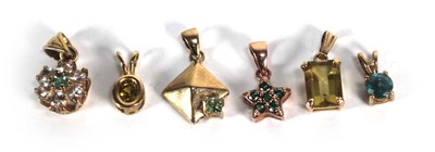 Lot 719 - Six 9ct yellow gold and yellow metal pendants,...