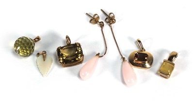 Lot 720 - Five 9ct yellow gold and yellow metal pendants,...