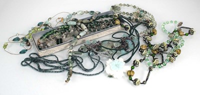 Lot 731 - A group of green hardstone, green glass and...