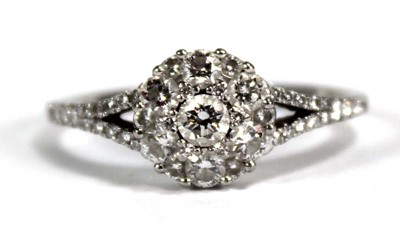 Lot 737 - A platinum cluster ring set seven brilliant...