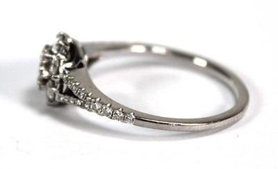Lot 737 - A platinum cluster ring set seven brilliant...