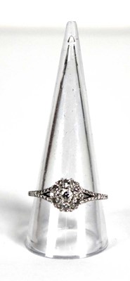 Lot 737 - A platinum cluster ring set seven brilliant...