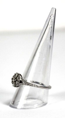 Lot 737 - A platinum cluster ring set seven brilliant...