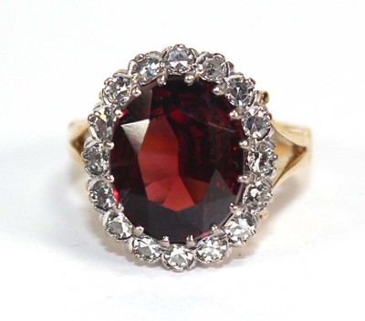 Lot 751 - An 18ct yellow gold cluster ring set oval...