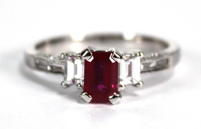 Lot 753 - An 18ct white gold ring set emerald cut ruby...