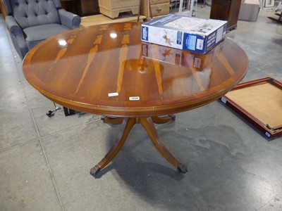 Lot 1358 - Circular single pedestal yew dining table on...