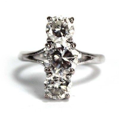 Lot 800 - An 18ct white gold ring set three graduated...