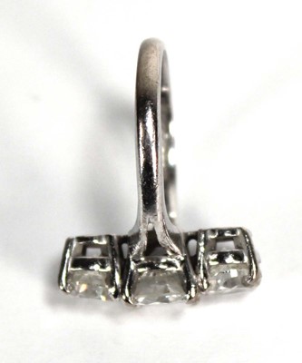 Lot 800 - An 18ct white gold ring set three graduated...