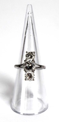 Lot 800 - An 18ct white gold ring set three graduated...