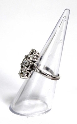 Lot 800 - An 18ct white gold ring set three graduated...