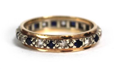 Lot 773 - A 9ct yellow gold eternity ring set sapphires...