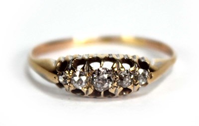 Lot 774 - A yellow metal ring set five graduated...