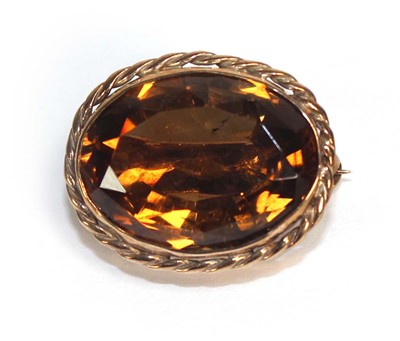 Lot 784 - A 9ct yellow gold oval brooch set Cairngorm...