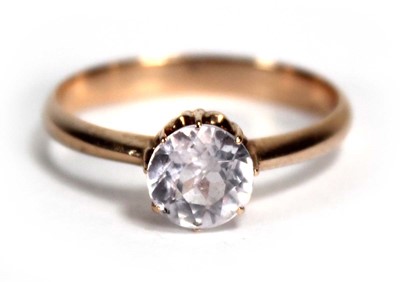 Lot 790 - A yellow metal ring set white sapphire in an...