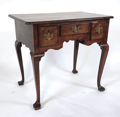 Lot 2 - A Georgian walnut lowboy with three frieze...