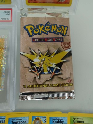 Lot Three assorted graded Pokémon cards/stickers...