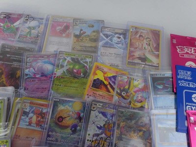 Lot Qty of Assorted Top Loaded Pokémon cards to...