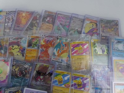 Lot Qty of Assorted Top Loaded Pokémon Cards to...