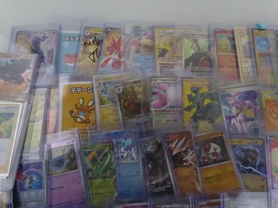 Lot Qty of Assorted Top Loaded Pokémon Cards to...