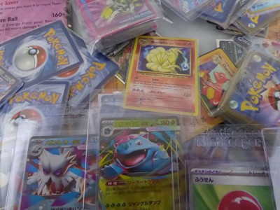 Lot Qty of Sleeved and Top Loaded Pokémon Cards to...