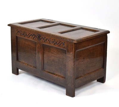 Lot 31 - An 18th century oak coffer, the panelled lid...