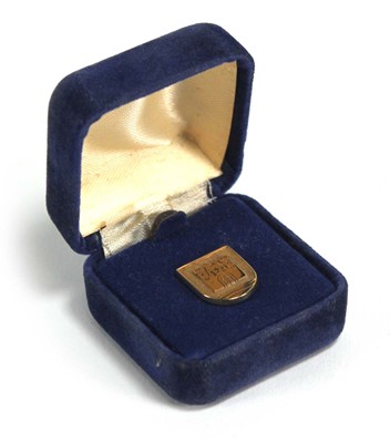 Lot 824 - A 9ct yellow gold tie pin of shield form with...