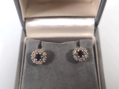 Lot 433 - A pair of white metal, sapphire and diamond...