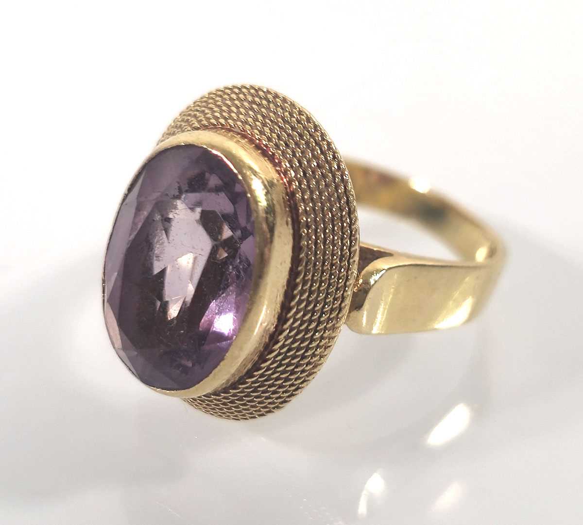 Lot 441 - An 18ct gold and amethyst dress ring. Approx....