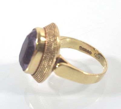 Lot 441 - An 18ct gold and amethyst dress ring. Approx....