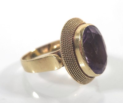 Lot 441 - An 18ct gold and amethyst dress ring. Approx....