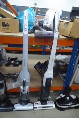 Lot 3156 - Two upright Bosch cordless vacuum cleaners....