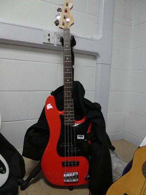 Lot 2465 - Squier 4 string bass guitar in red and black...