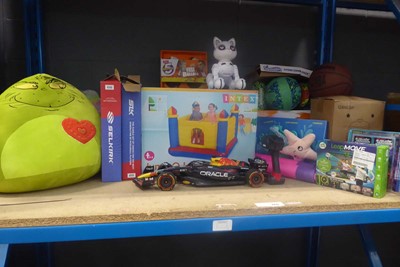Lot 3315 - Shelf of soft toys, inflatable racing car etc.