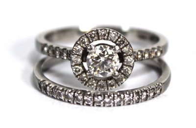 Lot 825 - A platinum halo ring set brilliant cut diamond...