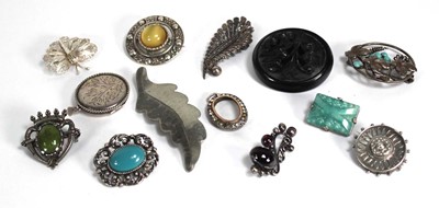 Lot 834 - Ten silver and metalware brooches including a...